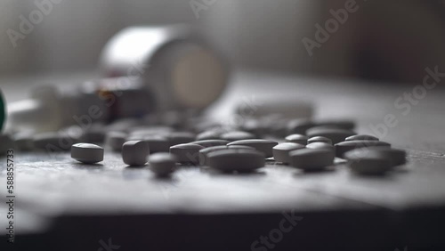 Close-up shot of pile of pills on table - mosern drug and pharmacy addiction, pharmaceutical industry concept 4k footage photo