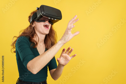 Happy redheaded woman with Virtual Reality goggles