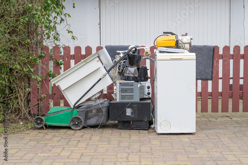 Bulky garbage heap with old electronic devices on the side of the road photo