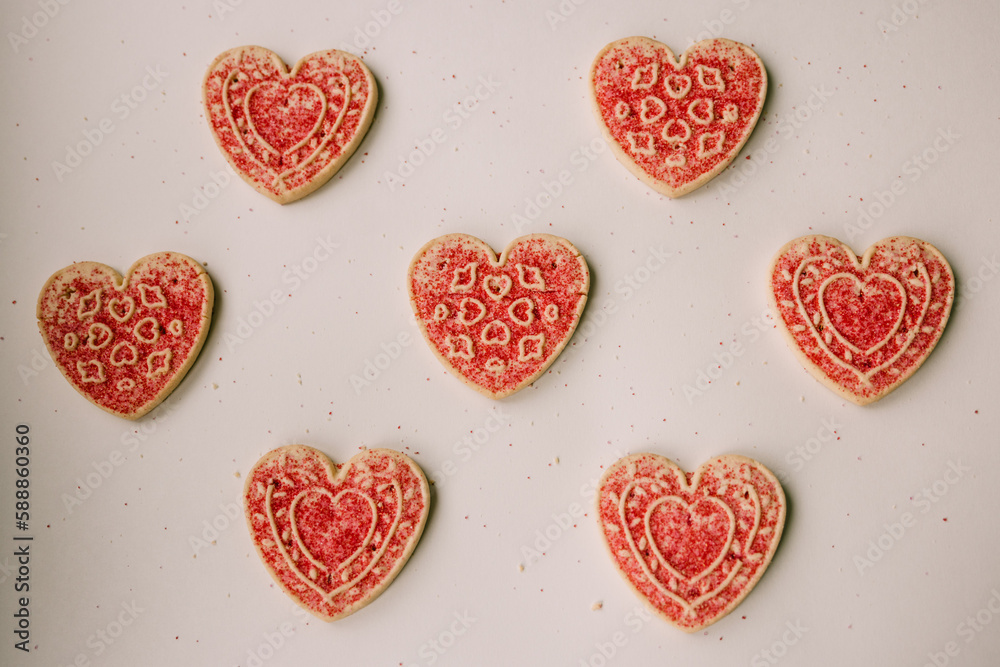 Fototapeta premium Heart cookie flat lay with bright sprinkles