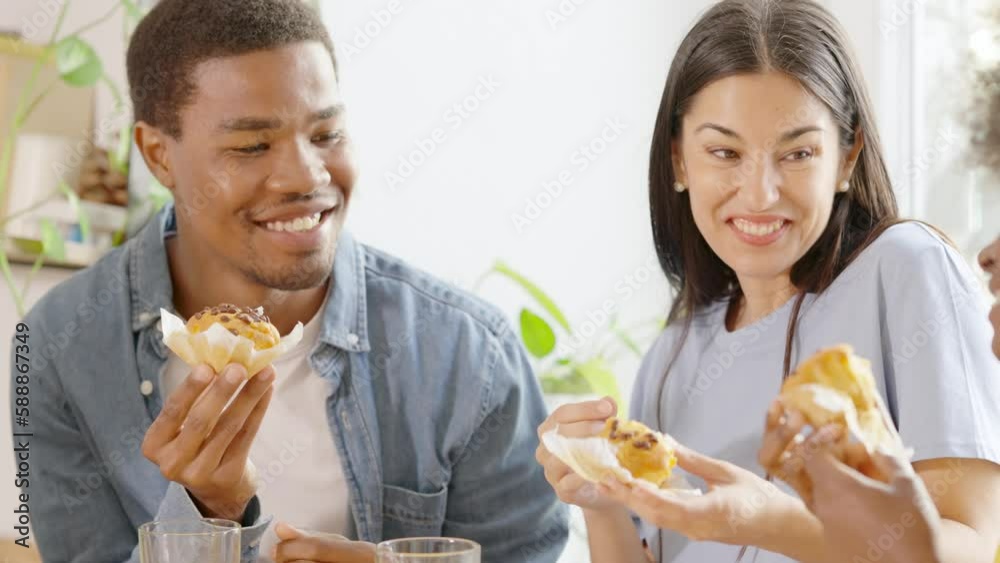 African man and woman chatting and eating breakfast with friends African man and woman chatting and eating breakfast with friends
