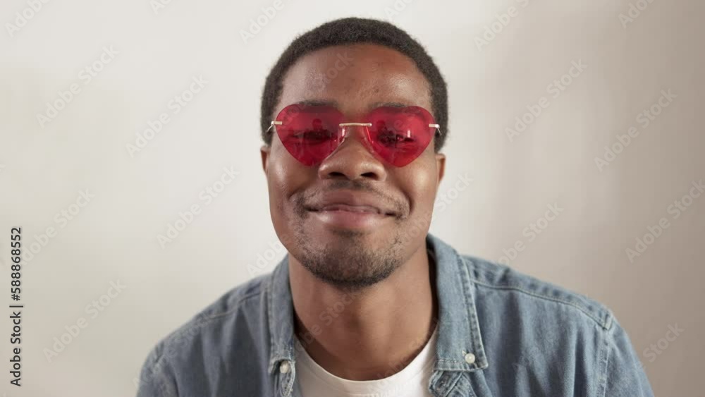 close up of an african man with heart shaped sunglasses close up of an african man with heart shaped sunglasses