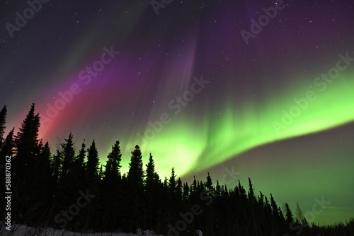 A colorful display of the aurora borealis, or northern lights, brightens a dark winter night near Fairbanks, Alaska.