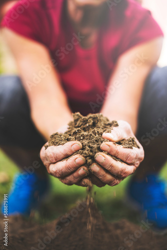 Senior woman holding soil in her hands