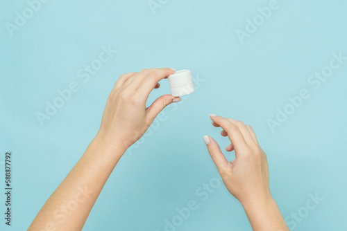 Woman's hands hold jar of cream or ointment. Packaging cosmetic product