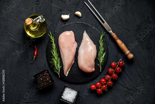 raw chicken breasts on stone background
