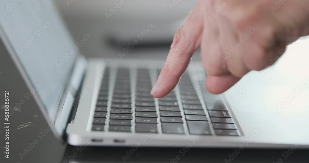 Grandma is very slow at typing on computer keyboard with only her index fingers. Close-up, side view, panorama, unrecognizable. Grandma is very slow at typing on computer keyboard with only her index fingers. Close-up, side view, panorama, unrecognizable.