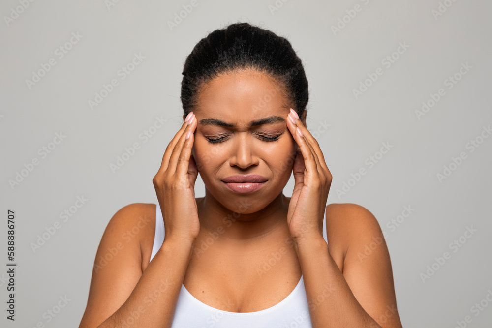 Closeup of young black woman suffering from headache Closeup of young black woman suffering from headache