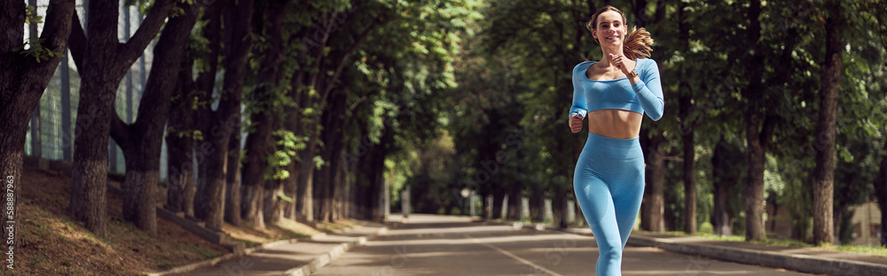Beautiful fit young woman jogger is running outdoors Beautiful fit young woman jogger is running outdoors