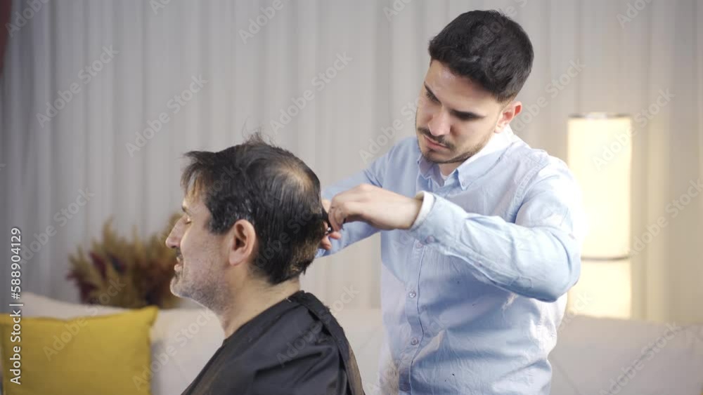 The son who cuts his father's hair.
Son shaving his father at home.
The son who cuts his father's hair.
Son shaving his father at home.