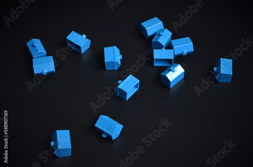 Blue Plastic Houses on a Black Background | Real Estate | Game Pieces