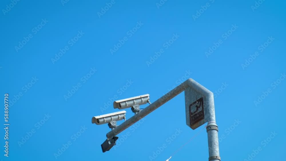 Recording security camera against sky. A view of security camera walking against sunny sky in summer. Recording security camera against sky. A view of security camera walking against sunny sky in summer.