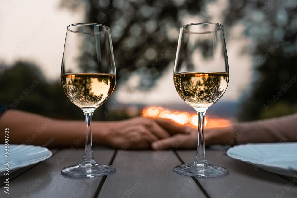 Couple holding hands in a romantic dinner setting 