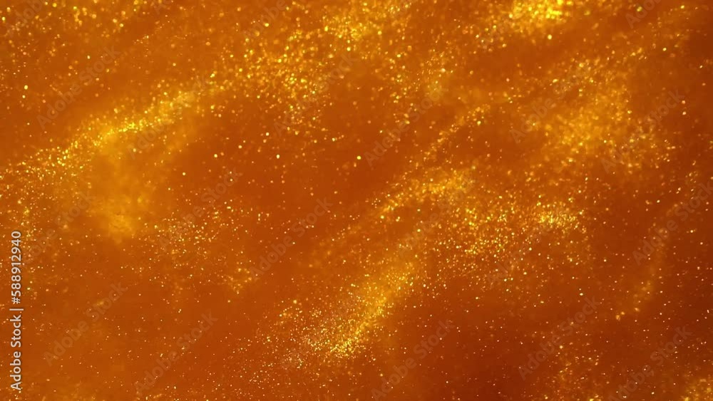 Sparkly Waves Of Gold Glitter Particles. Gold abstract background with golden sparkling glitter particles dust. Dispersion stains of shiny gold particles in fluid. 