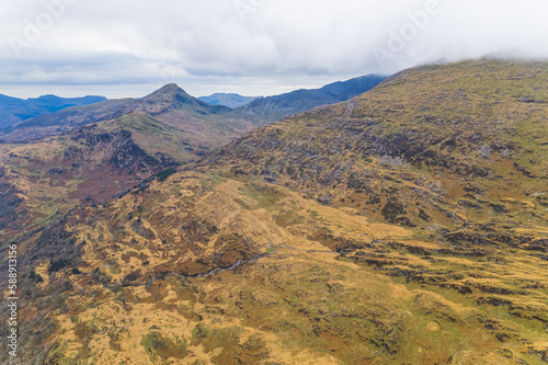 Stunning part of Snowdonia National Park, Wales seen from aerial view perspective. Cloudy sky over mountain range. High quality photo © PoppyPix