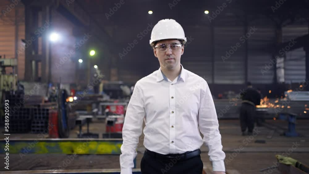 Shot of Professional Factory Worker Wearing Hard Hat Holds Tablet Computer, Walking Thorugh Modern Industrial Manufacturing Facility Shot of Professional Factory Worker Wearing Hard Hat Holds Tablet Computer, Walking Thorugh Modern Industrial Manufacturing Facility