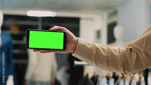 Wallpaper Mural Male employee holding greenscreen on mobile phone, using isolated chroma key display for commercial activity. Store assistant showing blank mockup template on smartphone. Close up. Torontodigital.ca
