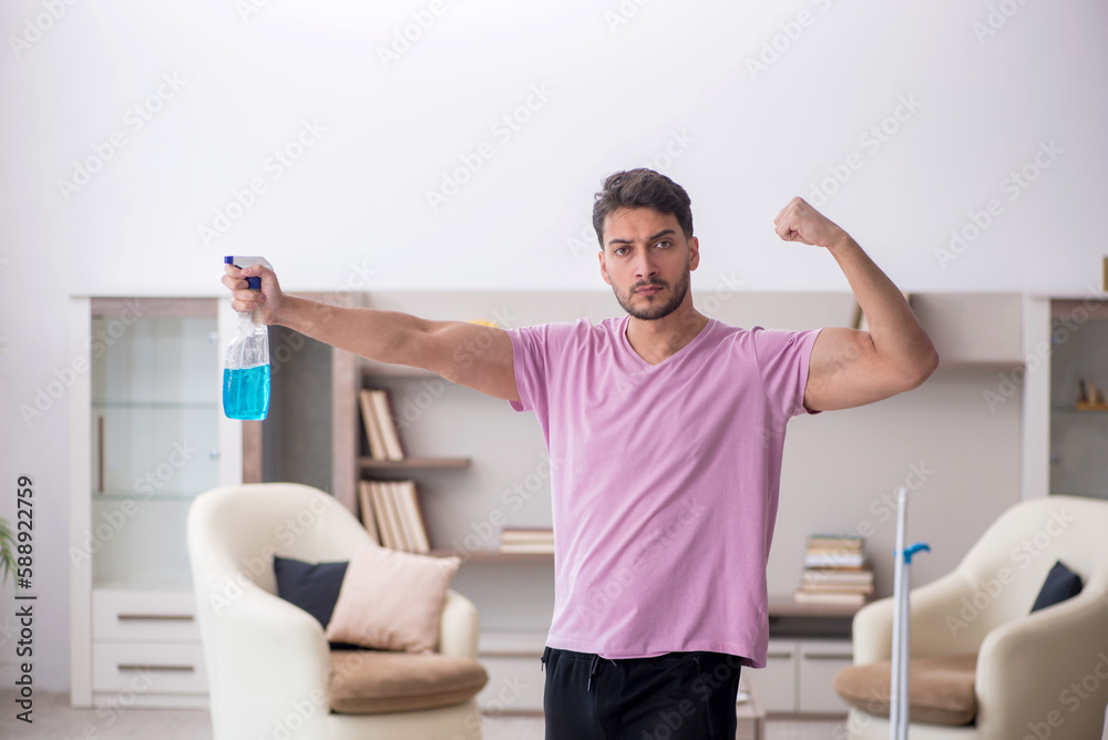 Fototapeta premium Young male contractor cleaning the house
