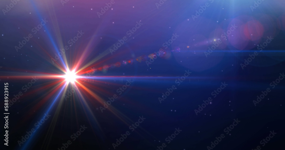 Fototapeta premium Image of colourful light trails over space with stars