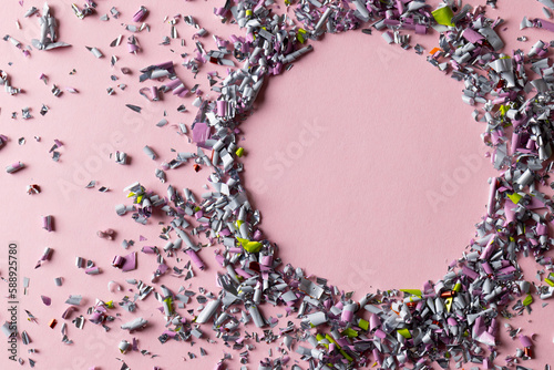Image of confetti and circle with copy space on pink background