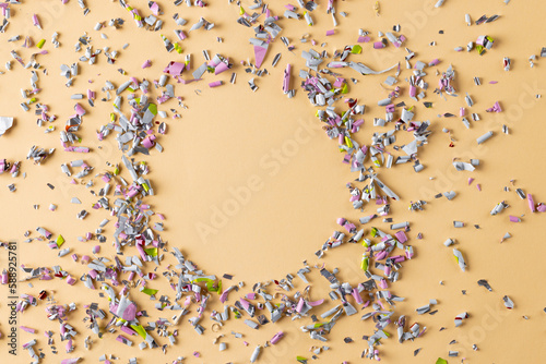 Image of confetti and circle with copy space on yellow background