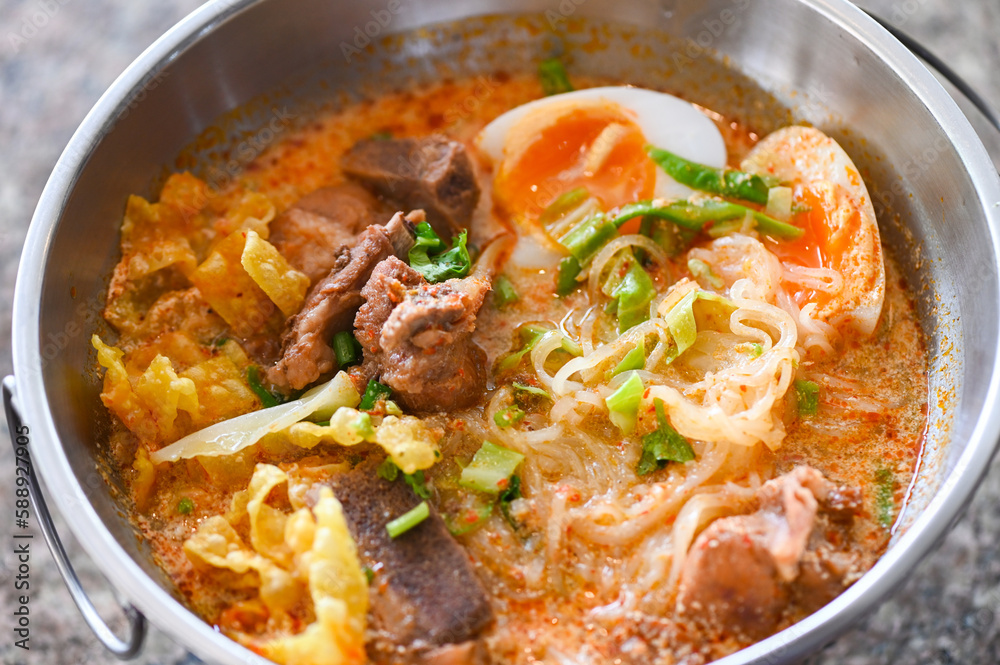 curry bone soup - bone noodle soup pork with boiled eggs in hot pot, Thai food tom yum hot and sour soup curry bone soup - bone noodle soup pork with boiled eggs in hot pot, Thai food tom yum hot and sour soup