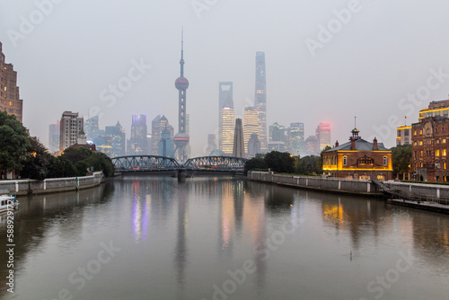 Skyscrapers of Pudong behind historical Waibaidu bridge in Shanghai, China