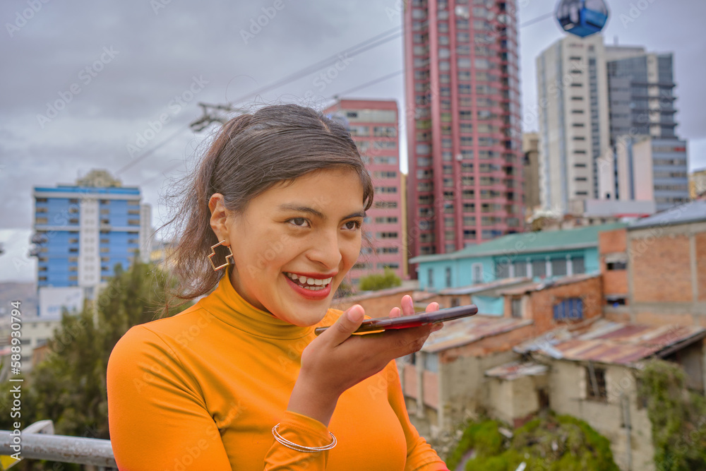Fototapeta premium Young Latina Woman Enjoying a Joyful Phone Conversation