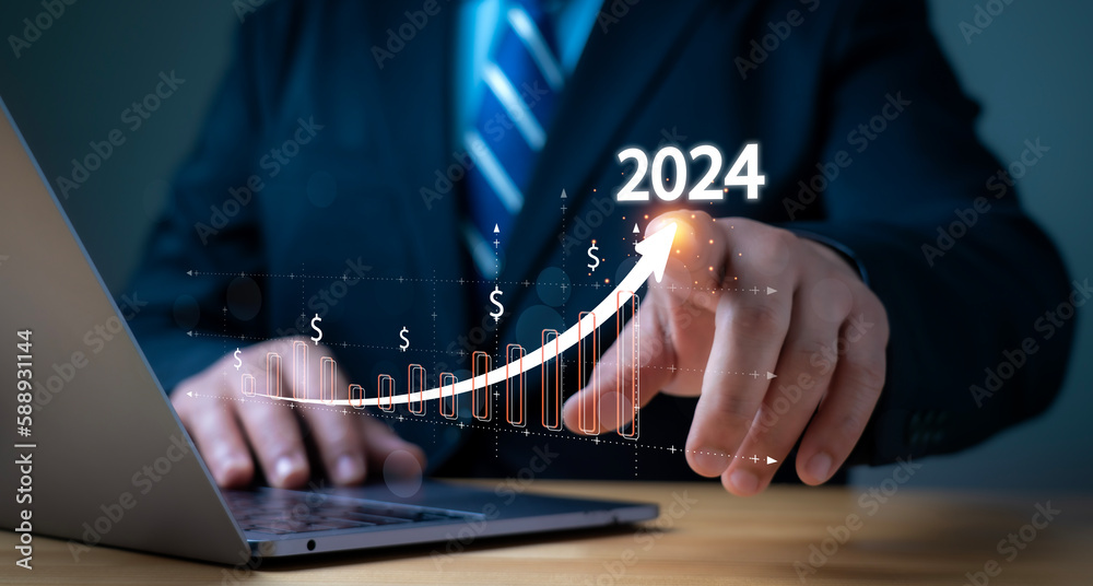businessman pointing a growing virtual hologram of statistics, graph ...