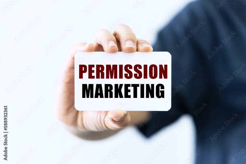 Permission marketing text on blank business card being held by a woman's hand with blurred background. Business concept about permission marketing. Permission marketing text on blank business card being held by a woman's hand with blurred background. Business concept about permission marketing.