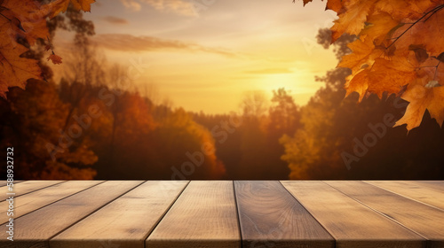 A wood table, a golden autumn sunset sky and leaf background for seasonal, autumnal thanksgiving images