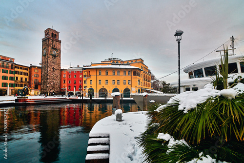 Riva del Garda town and Garda lake in the winter time on a snowy day,Trentino Alto Adige region
