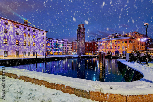 Riva del Garda town and Garda lake in the winter time on a snowy day Trentino Alto Adige region