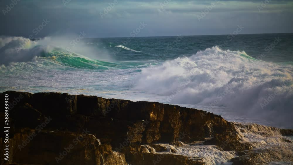 Huge waves breaking rocky beach in super slow motion. Powerful sea surf rolling Huge waves breaking rocky beach in super slow motion. Powerful sea surf rolling