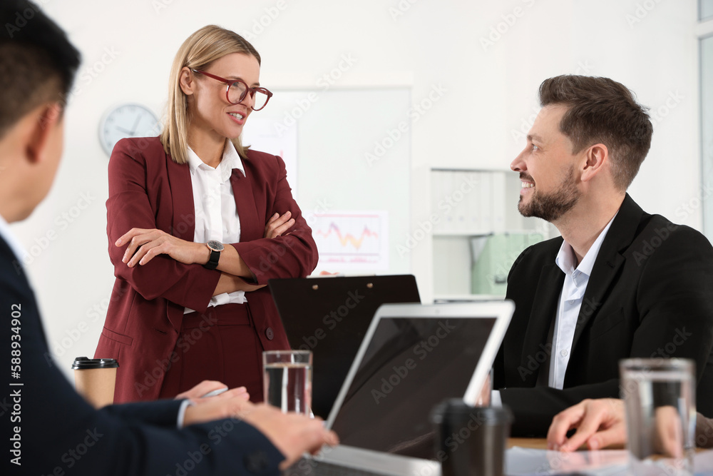 Businesswoman having meeting with her employees in office Businesswoman having meeting with her employees in office