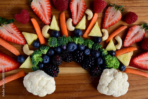 Closeup Fresh fruit and veggies arranged on butcher block, berries & vegetables fresh and healthy snacking
