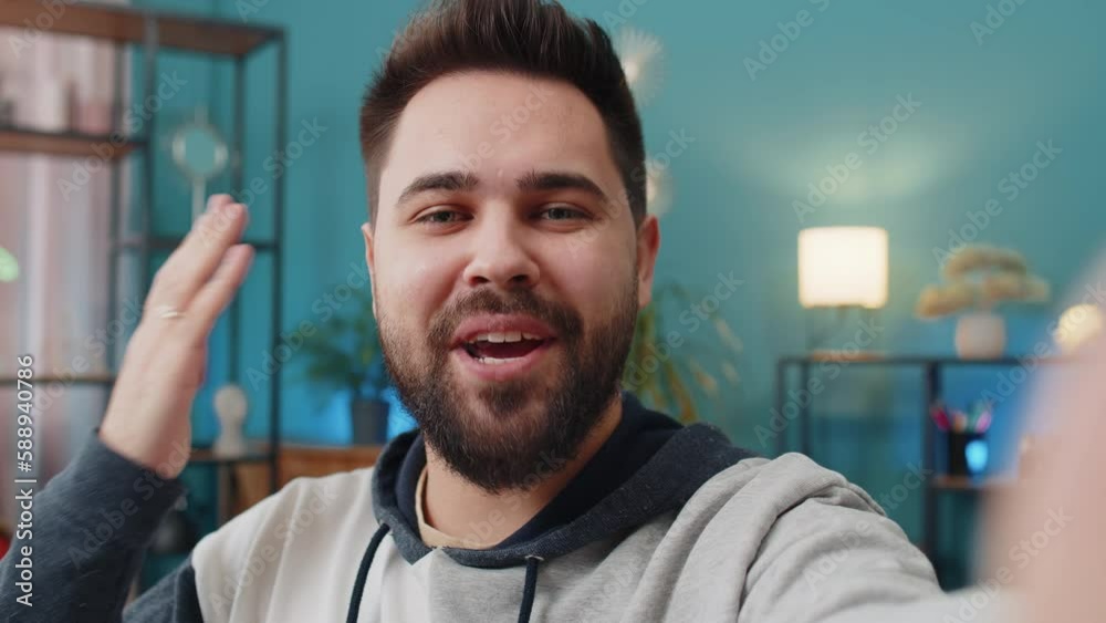 POV of Caucasian man blogger taking selfie on smartphone, communicating video call online with social media subscribers followers, recording vlog stories. Young guy at home apartment room on couch POV of Caucasian man blogger taking selfie on smartphone, communicating video call online with social media subscribers followers, recording vlog stories. Young guy at home apartment room on couch