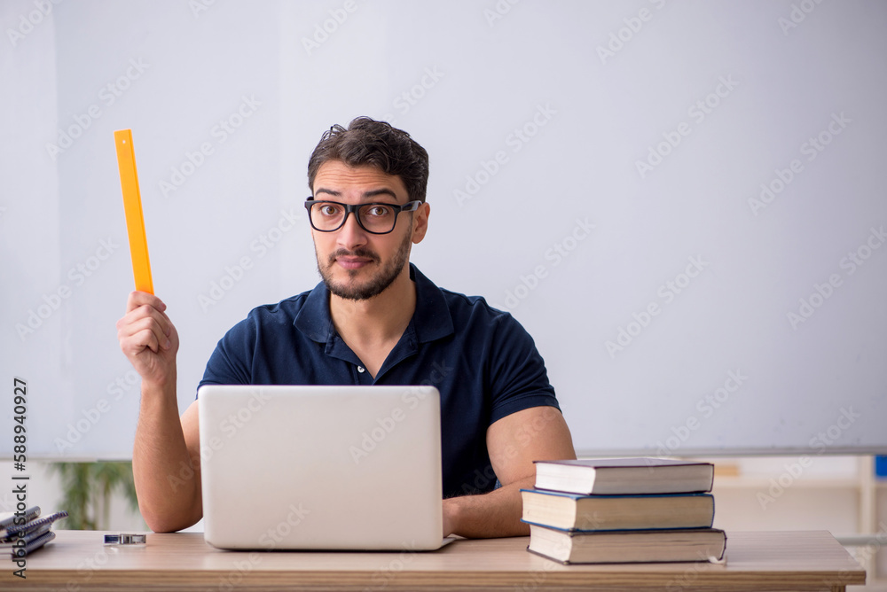 Young male teacher in telestudying concept