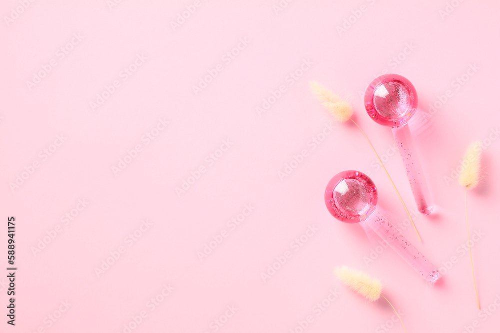 Ice globes massage tool for face on pink background