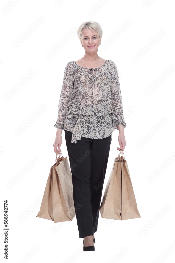 elegant young woman with shopping bags striding forward . elegant young woman with shopping bags striding forward .