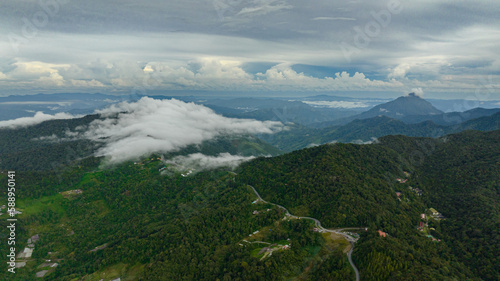 Aerial view of farmland and village of farmers in the mountains. Borneo, Sabah, Malaysia.