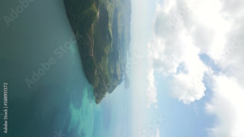 Vertical drone view over tropical island next to beautiful blue ocean photo