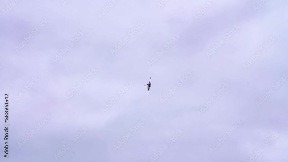 KAI T-50B Golden Eagle Jet Plane Flying In Steady Turn Under The Cloudy Sky. low angle, tracking shot KAI T-50B Golden Eagle Jet Plane Flying In Steady Turn Under The Cloudy Sky. low angle, tracking shot
