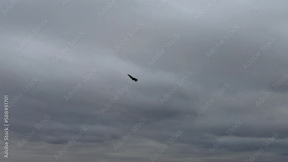 Silhouette Of An F-35A Lightning II Jet Flying In Cloudy Sky - low angle Silhouette Of An F-35A Lightning II Jet Flying In Cloudy Sky - low angle