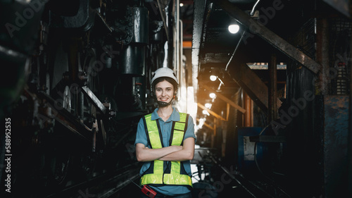 Portrait of Industrial engineer are working in the factory. Worker helping to repair and inspect the machine's readiness. Mechanical technicians are maintaining the engine in the train garage.