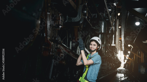 Engineer are working in the factory. Worker helping to repair and inspect the machine's readiness. Mechanical technicians are maintaining the engine in the train garage that is malfunctioning. © NewSaetiew