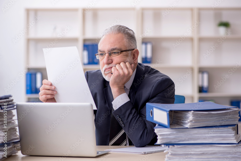 Old male employee and too much work at workplace Old male employee and too much work at workplace
