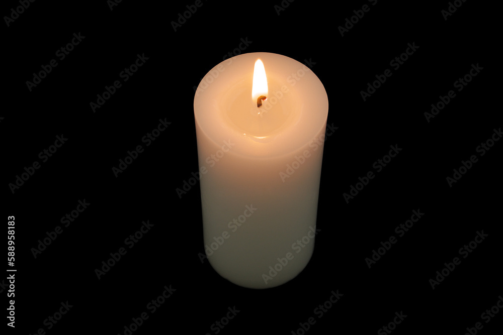 Top view of white burning candle isolated on black background.	