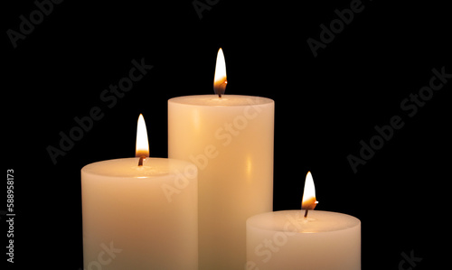Burning candles isolated on black background. Copy space for text. 