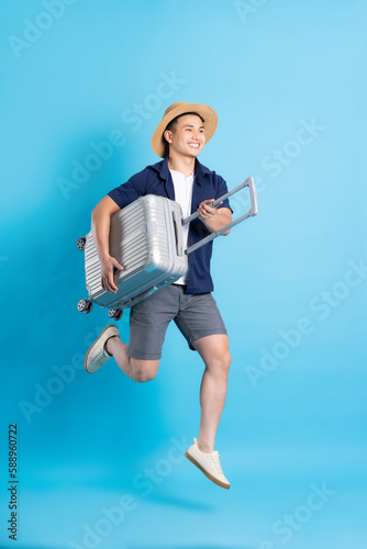 travel asian man portrait, isolated on blue background